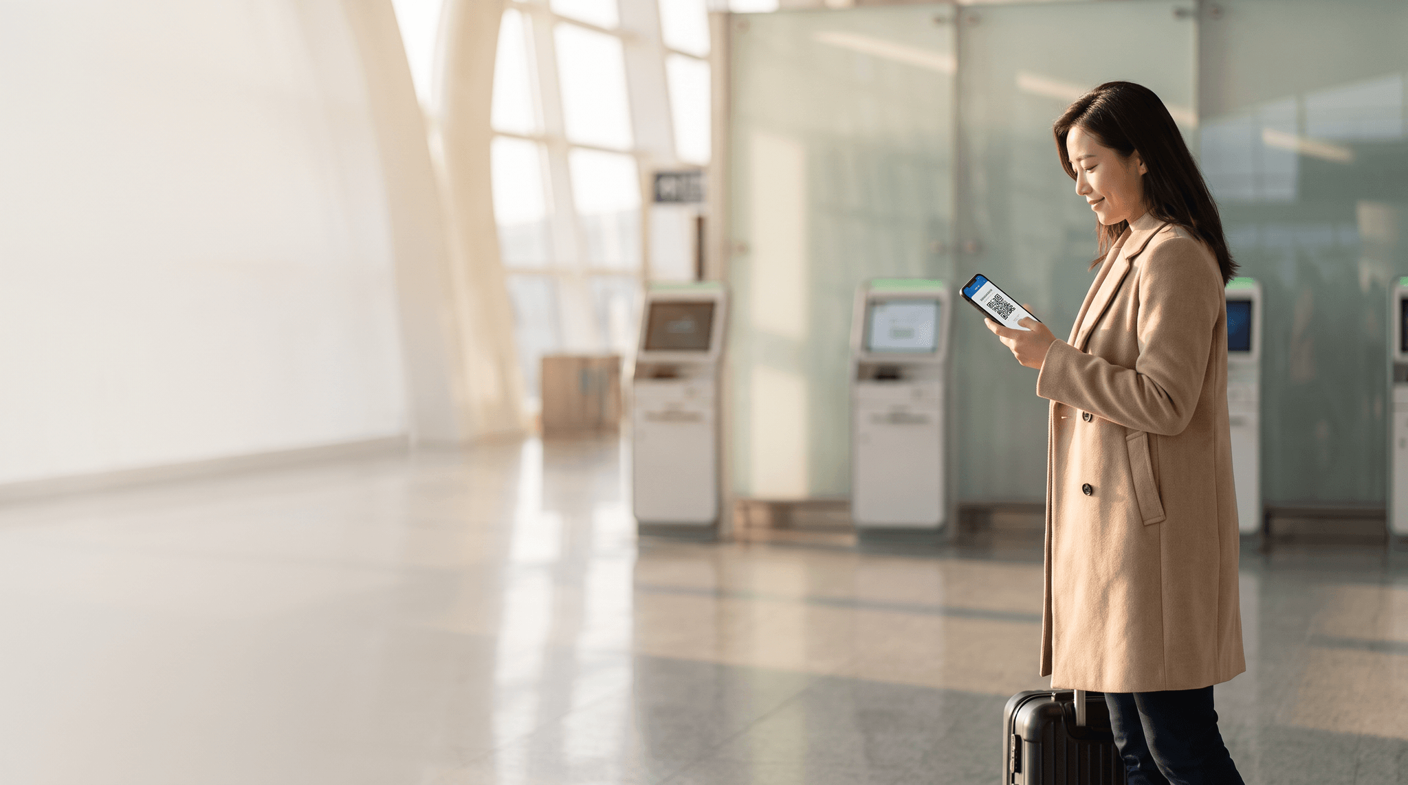 Traveler at a modern Chinese airport arrivals hall holding a phone showing an arrival card confirmation QR code