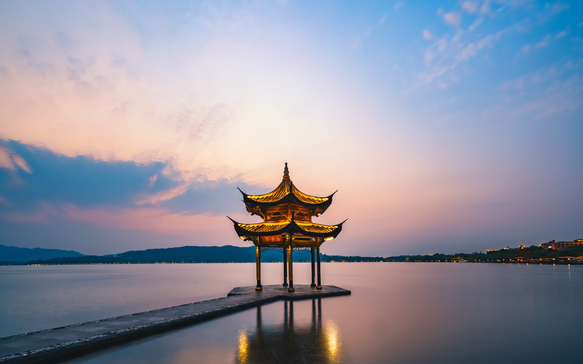 West Lake Hangzhou — Xi Hu viewed from the causeway with willow trees and hills in the background